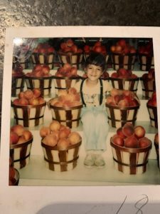 Puerto Rican Girl Sitting Next to Peaches in Gaffney, South Carolina